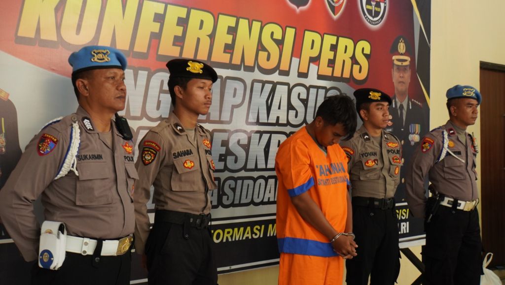 R.I tertunduk saat dihadirkan dalam press release di Mapolres Sidoarjo