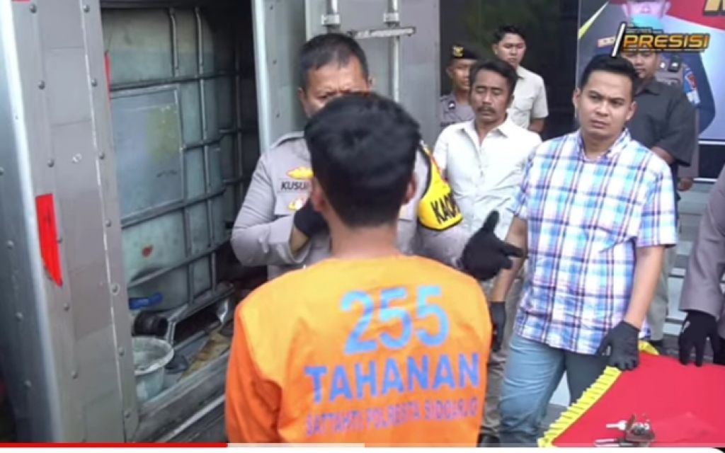 Wahyu Ria Kurniawan (baju tahanan) saat diinterograsi di depan mobil boks yang dimodifikasi