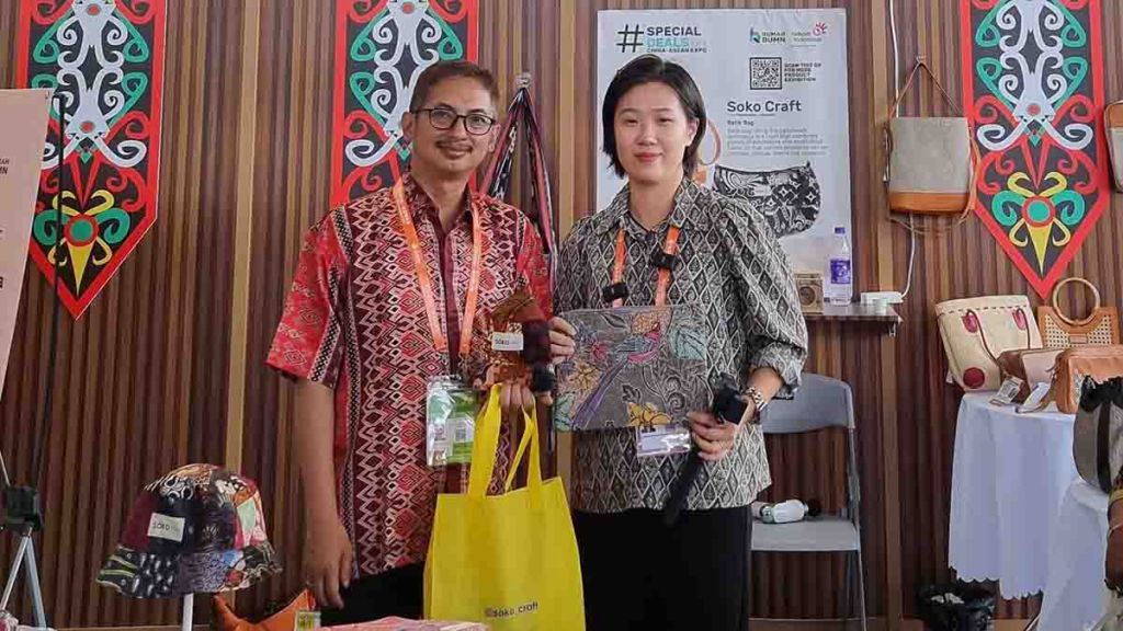 Achmad Retno Syafarie (kiri) bersama pengunjung yang membeli produk batik bag dari Soko Craft Pekalongan 